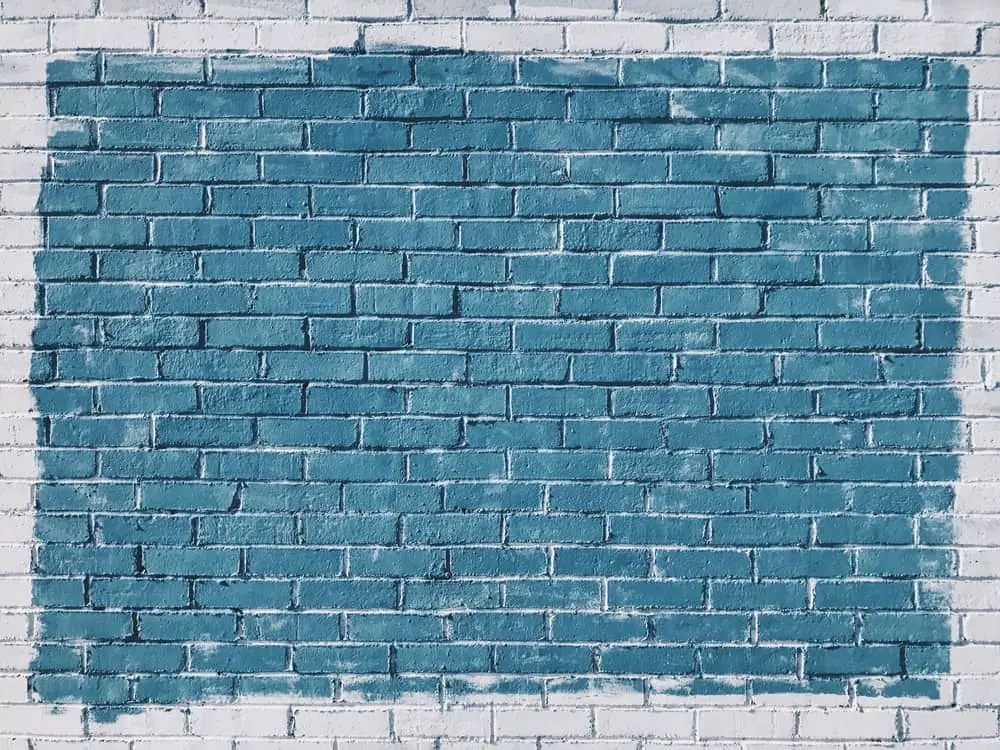 White brick wall with blue pain to signify a blank slide in a presentation