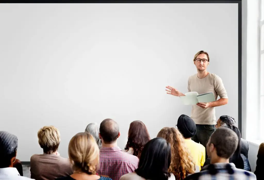 Man presenting to a crowd